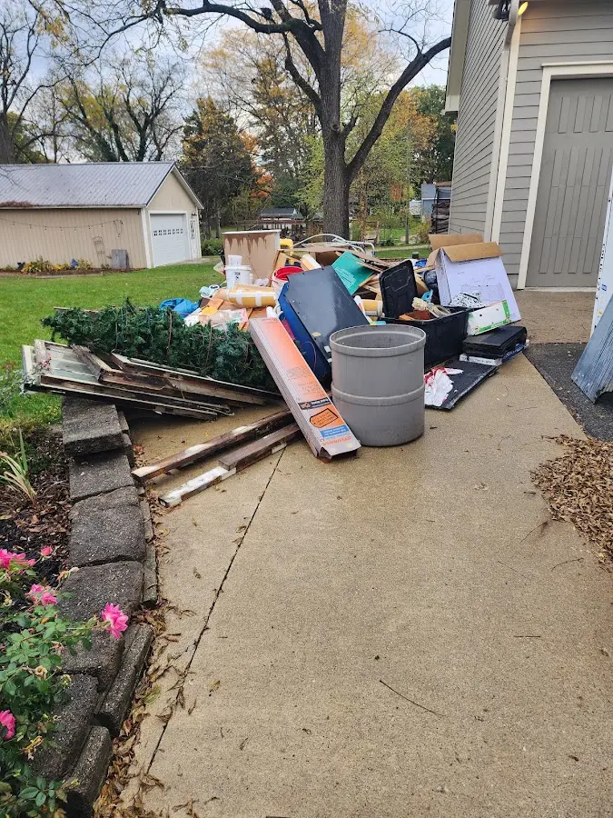 Dumpster being loaded with debris for 12 Yard Dumpster Rental in Liberty